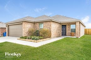Nevada house for rent - a brick house with a lawn and a driveway