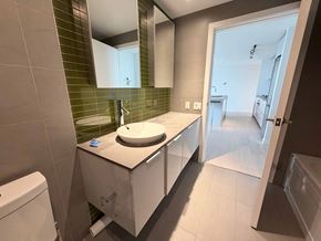 Vancouver apartment for rent - A bathroom with a sink, mirror, and toilet.