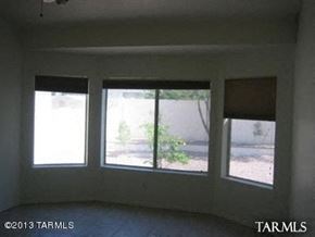 Marana house for rent - A room with three windows and a view of a street.