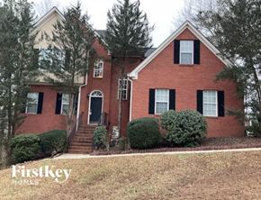 Mableton house for rent - a red brick house with black shuttered windows