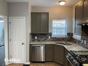 Mableton house for rent - a kitchen with stainless steel appliances and a counter top