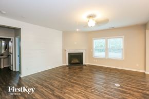 Denver house for rent - A spacious living room with a fireplace and wood flooring.