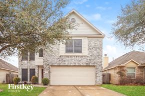 Humble house for rent - a white brick house with a white garage door