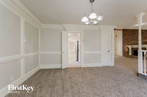 Spring house for rent - an empty living room with white walls and carpet