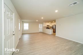 San Antonio house for rent - A spacious, empty room with wooden floors and white walls.