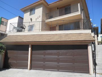 Los Angeles apartment for rent - A two-story house with a brown garage door.