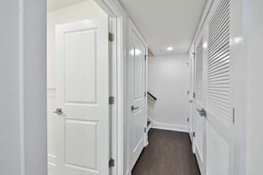 Philadelphia apartment for rent - a hallway with white closets and doors and a wood floor