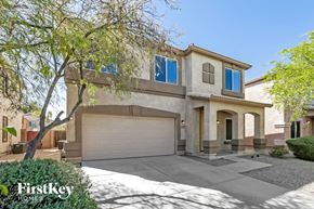 San Tan Valley house for rent - a house with a garage door and a tree