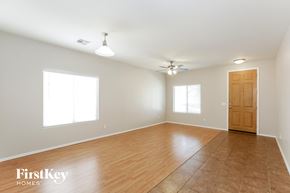 San Tan Valley house for rent - an empty living room with wood flooring and a ceiling fan