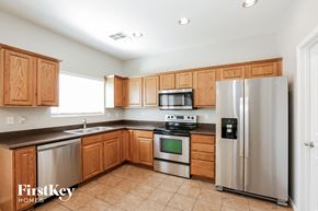 San Tan Valley house for rent - a kitchen with wooden cabinets and stainless steel appliances