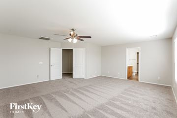 San Tan Valley house for rent - a spacious living room with carpet and a ceiling fan