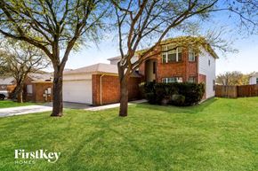 Schertz house for rent - A house with a green lawn and trees in front of it.