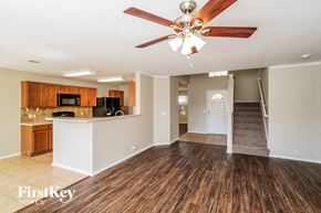 Schertz house for rent - A spacious room with a wood floor and a ceiling fan.