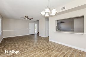 Glendale house for rent - the living room and dining room with wood flooring and a ceiling fan