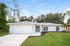 North Pt house for rent - a white house with a lawn and a driveway