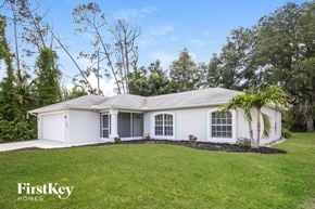 North Pt house for rent - a white house with a lawn and a palm tree