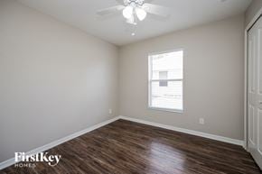 North Pt house for rent - a bedroom with wood flooring and a ceiling fan