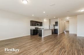 Buckeye house for rent - a living room and kitchen with wood flooring and white walls
