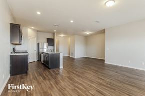 Buckeye house for rent - the living room and kitchen of an apartment with wood flooring and a kitchen island