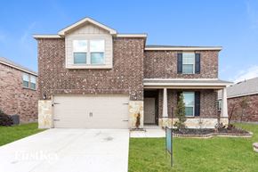 Forney house for rent - a brick house with a white garage door in front of a lawn
