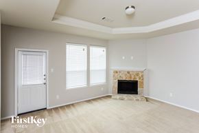 Forney house for rent - the living room of a new home with a fireplace and a door