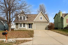 Kansas City house for rent - a house with a driveway and a garage door