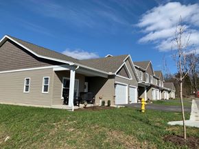 Penn Yan apartment for rent - a row of houses in a neighborhood with a yellow fire hydrant