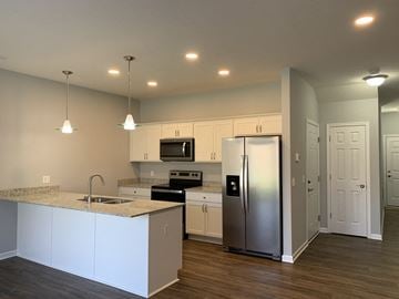 Penn Yan apartment for rent - a kitchen with white cabinets and a stainless steel refrigerator