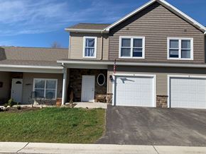 Penn Yan apartment for rent - a house with a white garage door on a driveway