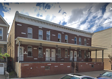 Elizabeth apartment for rent - A red brick building with a white trim and a balcony.
