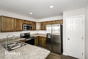 Jacksonville house for rent - a kitchen with stainless steel appliances and wooden cabinets
