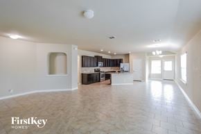 San Antonio house for rent - A spacious living room with a kitchen in the background.