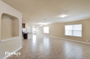 San Antonio house for rent - A spacious empty room with tile flooring and a large window.