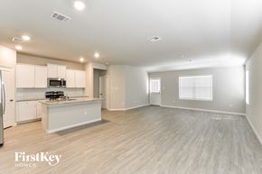 San Antonio house for rent - A spacious kitchen and living room with wooden flooring and white walls.