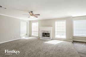 League City house for rent - a living room with a fireplace and a ceiling fan