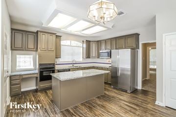 League City house for rent - a kitchen with stainless steel appliances and a marble counter top