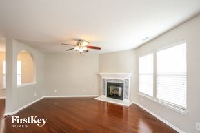 Franklin house for rent - a living room with a fireplace and a ceiling fan