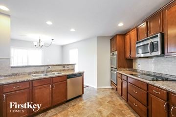 Franklin house for rent - a kitchen with wooden cabinets and stainless steel appliances