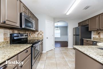 Middleburg house for rent - A kitchen with brown cabinets and a tiled backsplash.