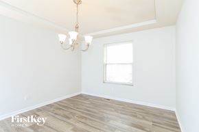 Fairfield house for rent - a bedroom with white walls and wood floors and a window