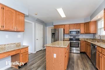 Fairfield house for rent - a kitchen with wooden cabinets and stainless steel appliances