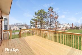 Fairfield house for rent - a large deck with a view of the yard and trees