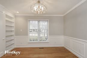 Clemmons house for rent - a dining room with white shelves and a window and a chandelier