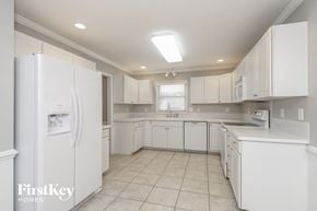 Clemmons house for rent - a white kitchen with white cabinets and white appliances