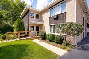Lisle apartment for rent - A house with a brown brick exterior and a white window.