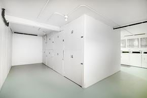 Lisle apartment for rent - A white room with numbered doors and a white cabinet with a black handle.