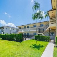 Hollywood apartment for rent - a mansion with a green lawn and palm trees