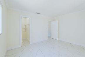 Hollywood apartment for rent - an empty living room with white walls and white marble floors