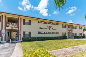 Hollywood apartment for rent - a building with a lawn and a sign that reads embassy house