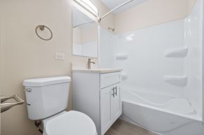 Villa Park apartment for rent - A white toilet sits next to a white sink in a small bathroom.